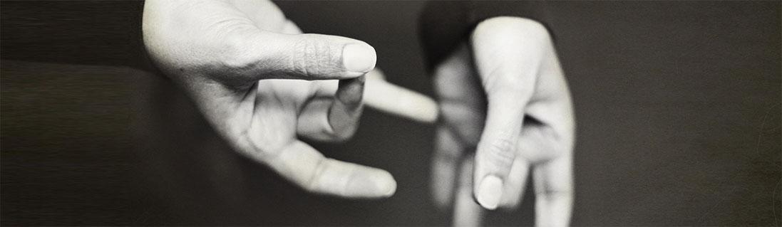 Image shows hands signing.