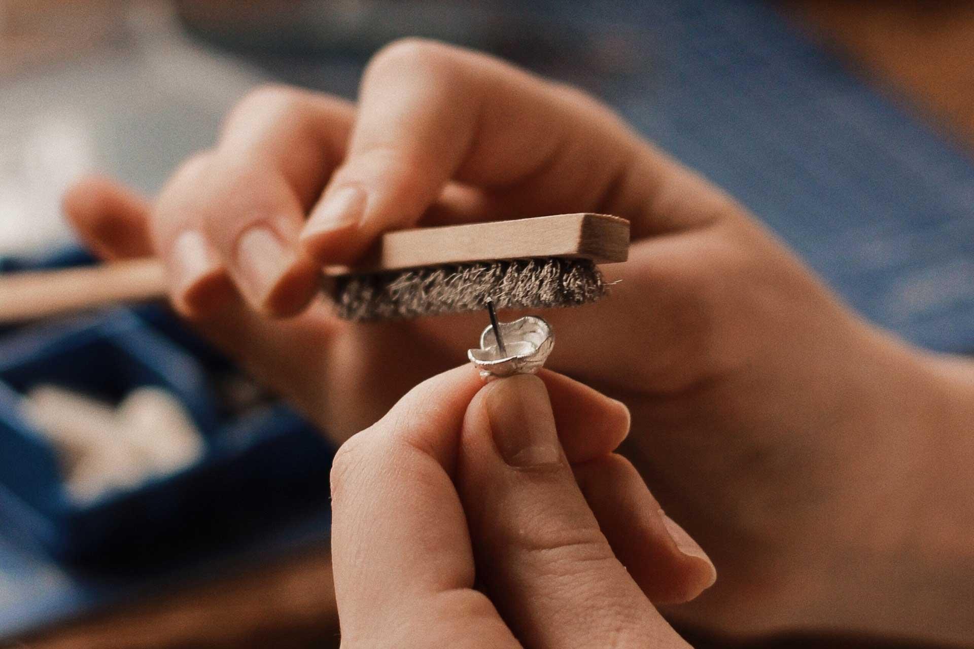 Image shows a person making jewellery.